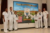 Capt. Kristen Atterbury and Navy Surgeon Vice Adm. General C. Forrest Faison join the navy artist who painted a mural commemorating the 50th anniversary of the hospital/clinic Thursday morning.